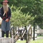 The replica miniature civil war era cannon and Cannoneer. 