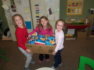 Some students showing off one of the boxes their class collected to donate to our canned food drive. (Photo courtesy Officer Devin Hogue w/the Atlantic P-D)