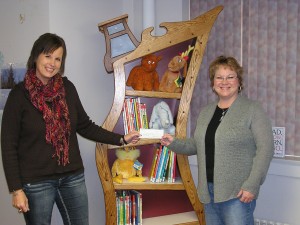 Melanie Petty (Left) presents a check to Librarian Julie Tjepkes. (Photo supplied by Petty)