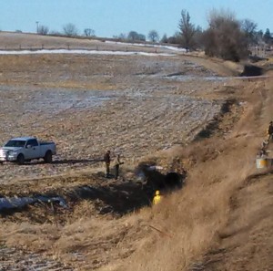 The vehicle is not visible from the road, but is near where the rescue worker in yellow is standing. (Ric Hanson/Photos)