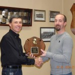 Mark McNees receives the "Firefighter of the Year" award from 2nd Asst. Fire Chief Tim Cappel. 