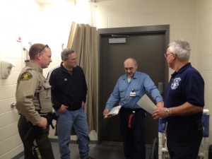 Jack Evans of the CCMH Plant Operations Department explains the decontamination area in the CCMH Emergency Department.  Shown from left are:  Darby Mclaren, Cass County Sherriff; Mike Kennon, Cass County Emergency Management Coordinator; Evans and John Johnson, Atlantic Fire Department and Medivac Ambulance. (Photo from Sara Nelson/CCMH)