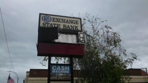 Exchange State Bank sign riddled by hail