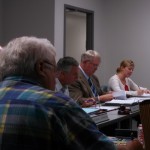 Iowa Western President Dr. Dan Kinney (Center, tan sport jacket) speaks at the meeting held in Atlantic. 