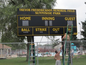 3 Atlantic Park and Rec employees finishing the scoreboard installation. Thanks to Bill Welter, CEO of Concept Builders, for donating his time and machinery to install the scoreboard and to the Cass County Community Foundation for their grant to purchase the scoreboard. (Roger Herring photo)