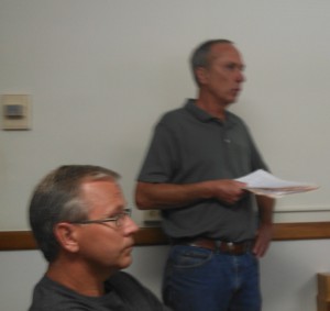 Corey Sindt (left) listens as Rich Hansen speaks to the Supervisors about the zoning matter.