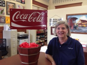 Dolly Bergman with a one of kind metal sign created by Weirich Welding, to be raffled off. 