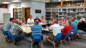 Members of the Adair-Casey School Board (far left) holds talks with CAM Board members (near side). 