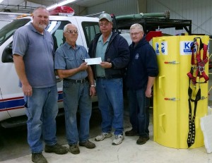 Photo: Tim Wahlert, Exira fire department; Mike Bintner, Exira fire chief; Jerry Riesgaard, Pioneer sales rep; Mike Davis, Exira fire department. (Photo provided)