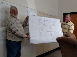 Cass County Engineer Charles Marker (left) & Supervisor Gaylord Schelling w/a map of County pipe/bridge projects. 