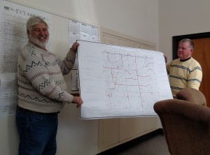 Cass County Engineer Charles Marker (left) & Supervisor Gaylord Schelling w/a map of County pipe/bridge projects.
