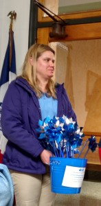 Kate Olson holds one of the "Pinwheels for prevention," bringing awareness to child abuse & prevention.