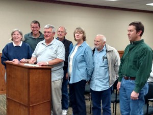 Atlantic Mayor Dave Jones, surrounded by the local Trees Forever group, signs the annual Arbor Day Proclamation.