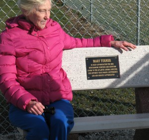 Mary Turner sits on the bench placed in her honor at the Buck Creek Dog Park.