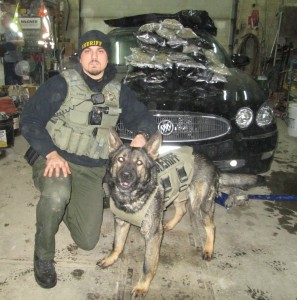 Tyler Shiels w/his K9 partner and the drugs seized. (photo courtesy the Cass Co. S/0)