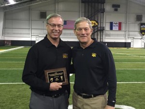 KJAN's Jim Field receives his IFCA Distinguished Service Award from Iowa Football Coach Kirk Ferentz