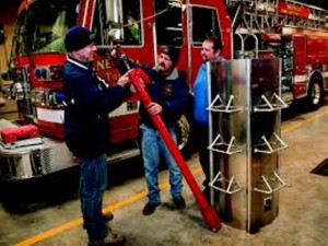 Grain bin rescue auger (red device in the center) & a type of rescue tube (on the right). (Photo from the IA Farm Bureau.com website)