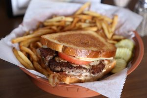Chuckwagon Burger – a burger served on a grilled bun with sautéed onions, mushrooms, bacon, tomato and Thousand Island dressing.