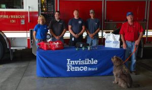 Shelly Jenkins with Invisible Fence® Brand of the Heartland presents the pet oxygen masks to Montgomery County Emergency Management Director Brian Hamman, Red Oak Fire Chief John Bruce and Grant Fire Chief Greg Vetter.