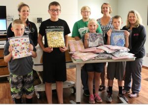 In the photo are club members Reagan Carney, Jaden Carney, Wyatt Rudy, Justin Davis, Bryce Rochholz, club leader Cindy Lundy, and CCMH OB nurses Britni Olson and Kate Nachtman.