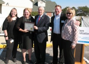 Gov. Terry Branstad presents the award to ASC Adminstrator Kellie Jimerson.