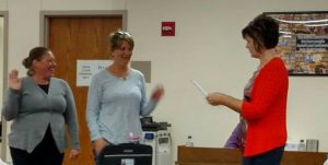 Board Secretary Mary Beth Fast administers the School Board Oath of Office to Ali Bruckner (Left) and Jenny Williams (Center)