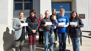 Nonprofit representatives receiving grant awards: 1st row from left to right:  Lexi Christensen and Peggy Tuft, City of Exira; Dillon and Alex Clemsen, Exira Fire & EMS Association; Linda Blomme, Audubon Community Cinema; Abby Rasmussen, Exira Community Club. Back row: Audubon County Community Foundation board members Shelley Burr and Genelle Deist (Chair).