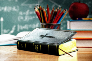 Bible in the classroom Photo illustration by Slate. Photos by artisteer/Getty Images Plus and Pra-chid/Getty Images Plus.